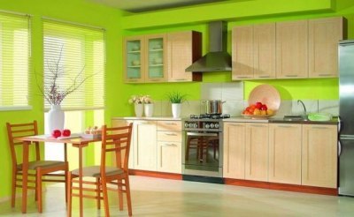 Kombinácia svetlozelenej farby v interiéri kuchyne s kontrastnými červenými detailmi